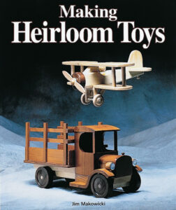 book cover with a wooden truck and wooden plane on it
